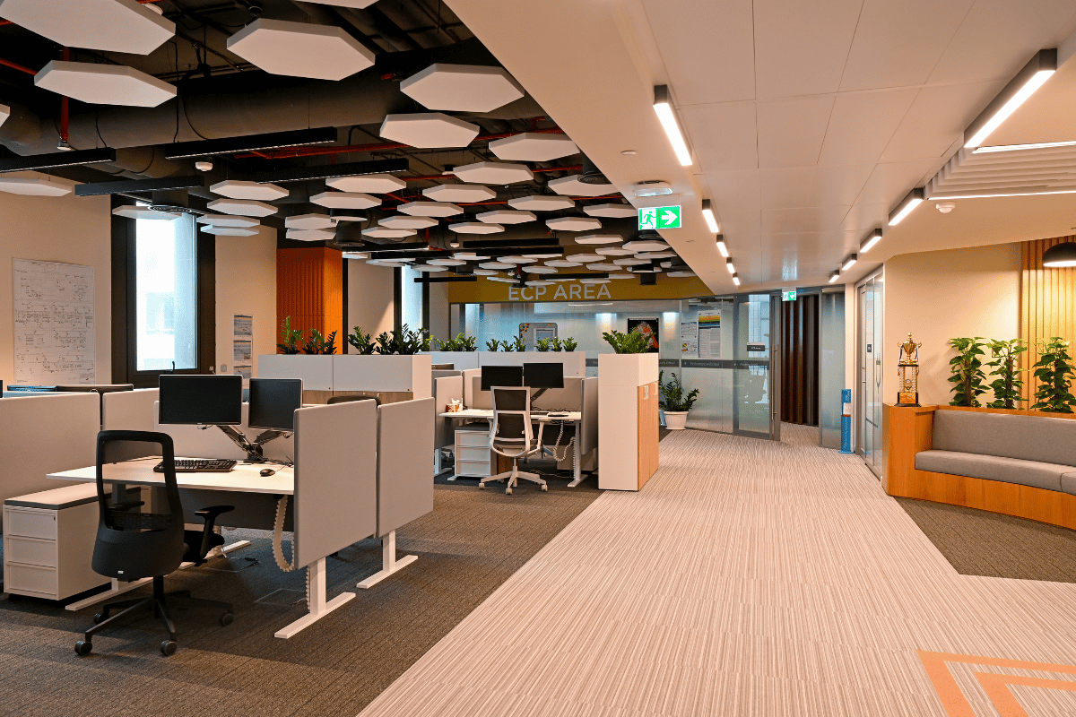 A large, modern conference room in corporate offices with advanced audiovisual equipment, showcasing a thoughtful fit out project.